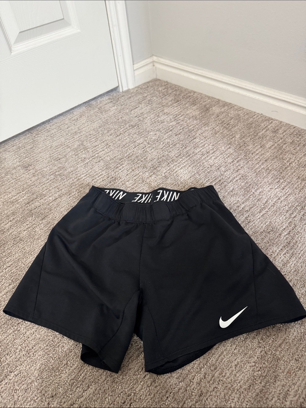 Nike Black Women's Athletic Shorts with White Swoosh and Branded Waistband